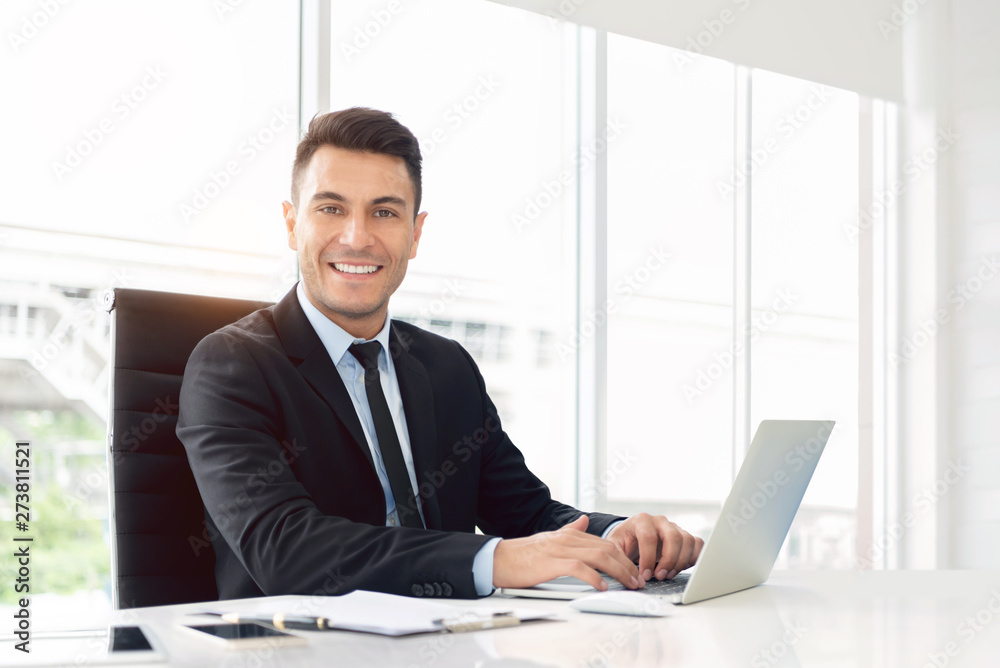 Portrait of a Happy businessman working on laptop. Portrait of a Happy businessman working on laptop.
