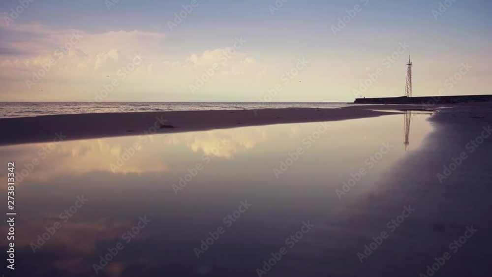 Blue ocean waves lapping over empty beach. Amazing sunset landscape. Slow motion footage. Steadicam. Blue ocean waves lapping over empty beach. Amazing sunset landscape. Slow motion footage. Steadicam.