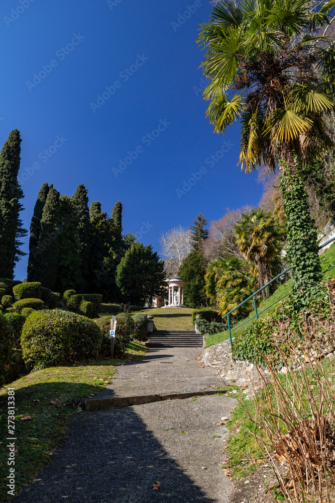 The path to the rotunda with a statue in the park of Villa D'Este. Cernobbio. Lake Como, Northern Italy.