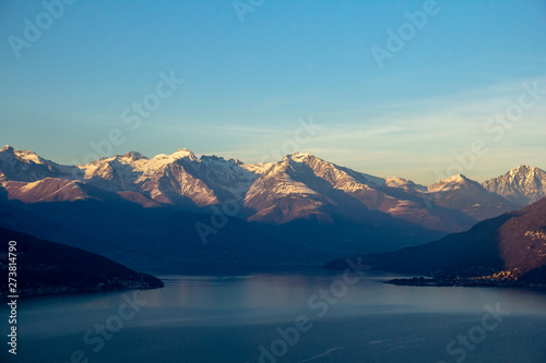 Flight over Lake Como at sunset. View of the mountains  Alps  in the light of the setting sun. Italy