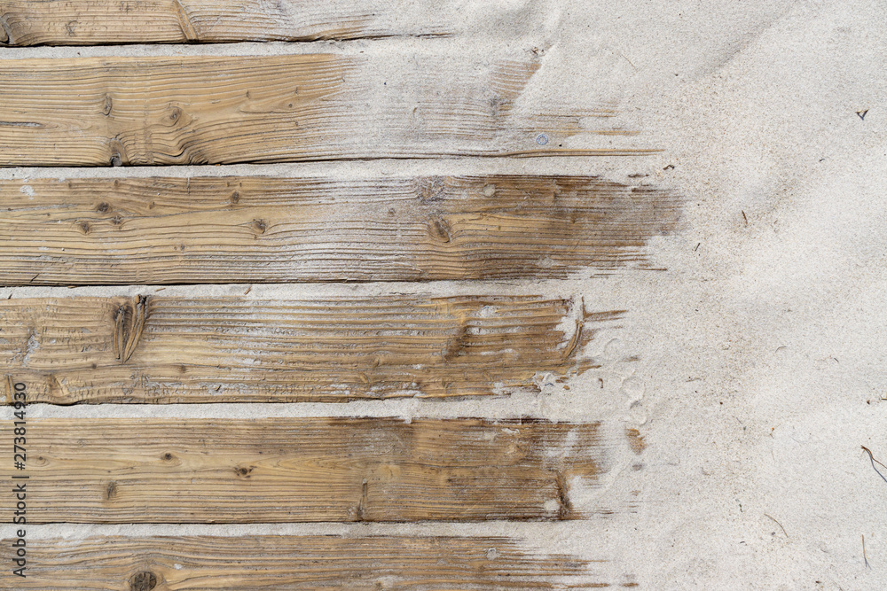 Weathered Wooden Boardwalk on Sand / Aged beach brown wooden floor over summer sand - obrazy, fototapety, plakaty 