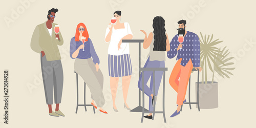 A group of young people having fun in a cafe. Guys and girls drink wine and cocktails at a party.