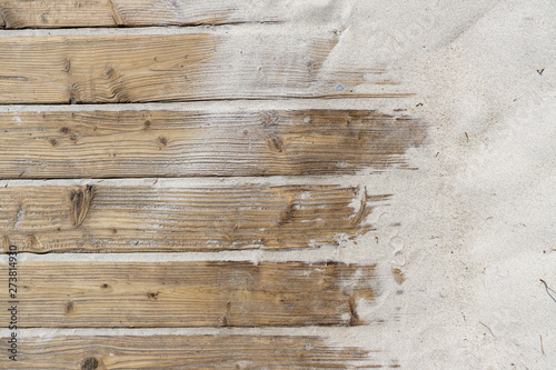Weathered Wooden Boardwalk on Sand / Aged beach brown wooden floor over summer sand