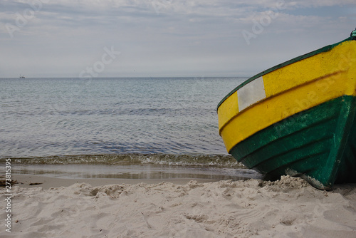 An old wooden fishing boat on the beach in Poland. Baltic Sea.