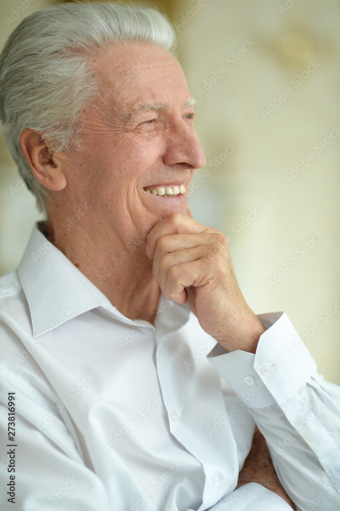 Happy beautiful smiling senior man posing at home Happy beautiful smiling senior man posing at home