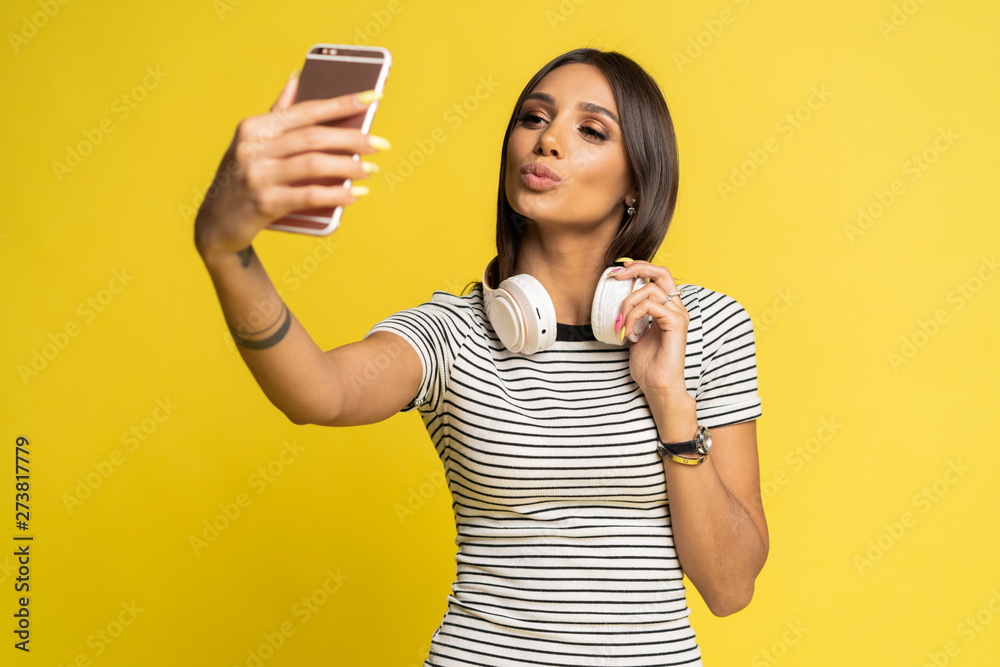 Portrait of a pretty girl taking a selfie isolated over color background. Portrait of a pretty girl taking a selfie isolated over color background.
