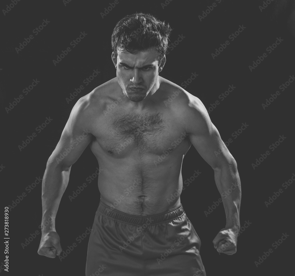 Portrait of strong angry fitness man on dark background Portrait of strong angry fitness man on dark background