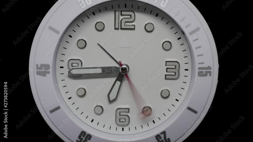 Timelapse shot of an analog white clock over a black background: fast moving hands, more than an hour in a few seconds, going from six to seven and beyond. Timelapse shot of an analog white clock over a black background: fast moving hands, more than an hour in a few seconds, going from six to seven and beyond.