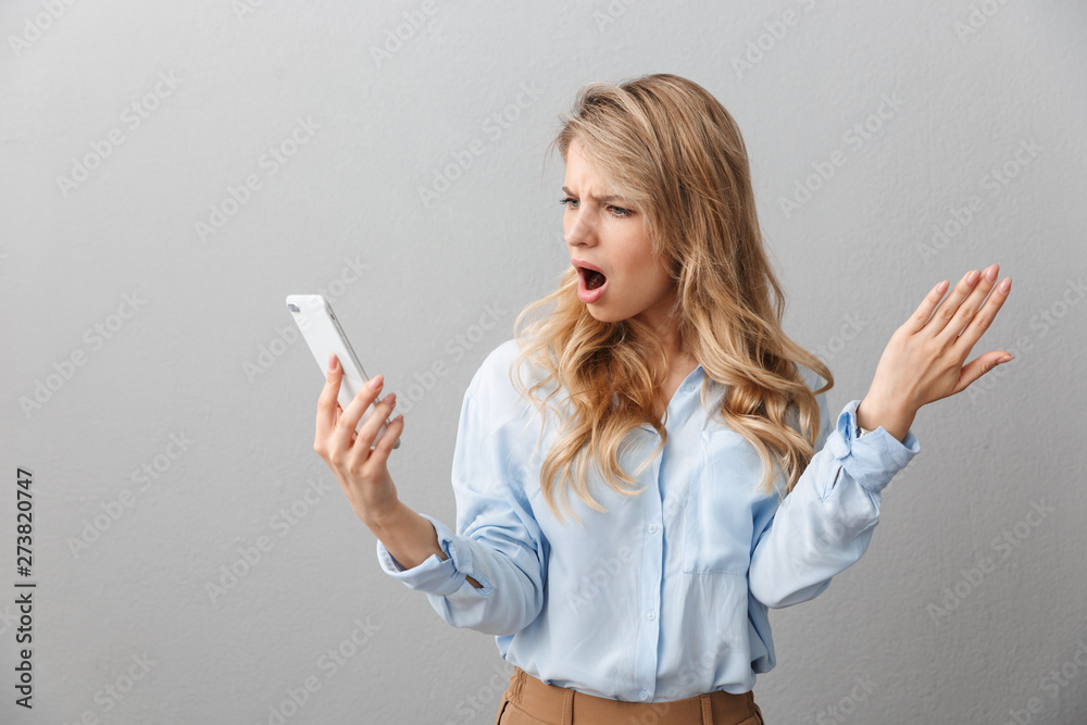 Photo of tense puzzled businesswoman with long curly hair worrying while calling on smartphone Photo of tense puzzled businesswoman with long curly hair worrying while calling on smartphone