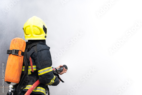 firefighters spray water on white background
