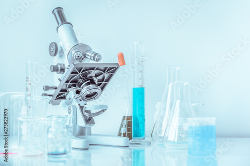 microscope and tubes with blue liquid