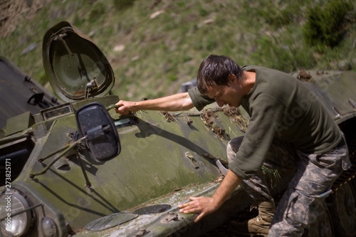 Soldier near the damaged armored personnel carrier.