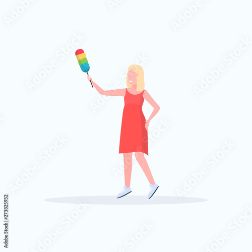 smiling housewife holding dust brush woman cleaner dusting cleaning service housework concept full length flat white background