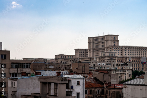 Legacy of communism and landmarks of Romania concept theme with the People's house (casa poporului) surrounded by communist apartment buildings. The building serves as Romanian palace of parliament
