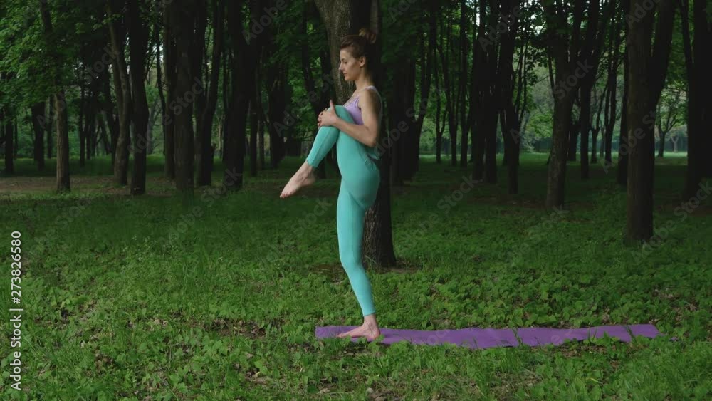 Young sport girl practicing yoga in uninhabited forest. Peace and solitude with nature. Relax and rest from everyday problems Young sport girl practicing yoga in uninhabited forest. Peace and solitude with nature. Relax and rest from everyday problems