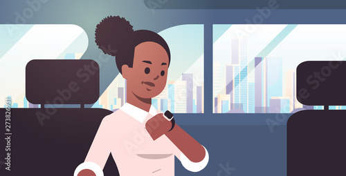 young businesswoman checking time african american woman car passenger sitting on back seat in taxi cab city transportation service concept flat portrait horizontal