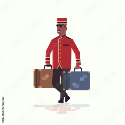 bell boy carrying suitcases service concept african american bellman holding luggage male hotel worker in uniform full length flat