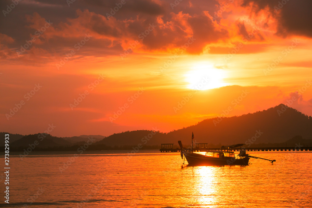 Silhouette of beautiful sunset with fishing boat