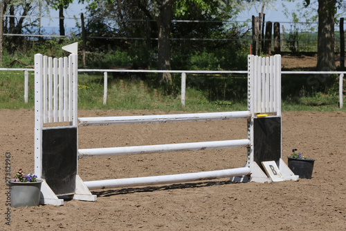 Outdoors photo of wooden barriers for jumping horses. Preparation of horses for performance on equestrian training