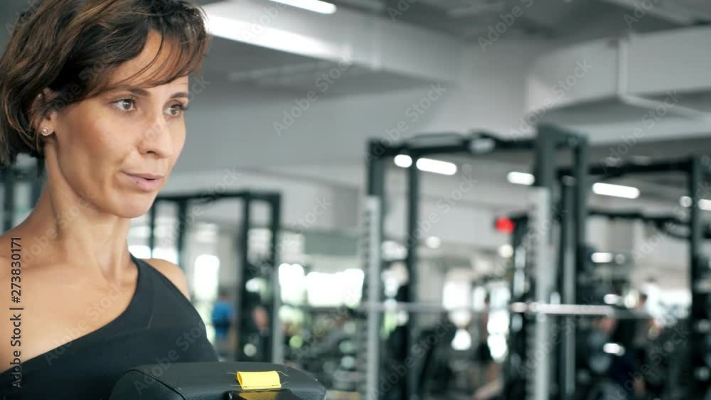 close up of sportive woman is doing exercises for spine muscles on block simulator, front view. close up of sportive woman is doing exercises for spine muscles on block simulator, front view.