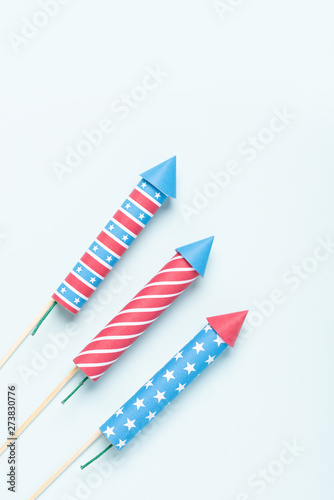 4th of july firework. USA flag style rockets on blue background top view. Independence day celebration firecrackers.