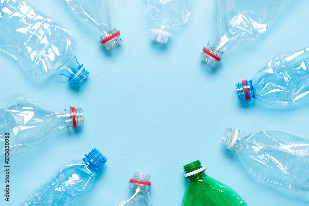 Plastic bottles on blue background top view. Recycle plastic waste