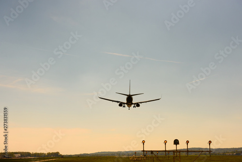 Airplane airport landing at sunset