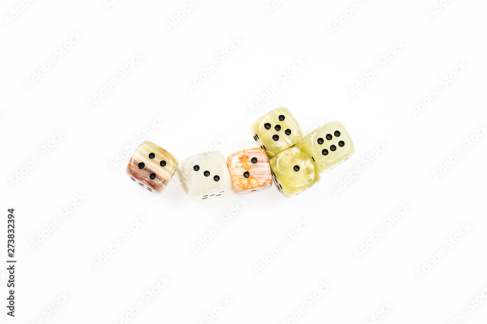 Dices made of natural stone on a white background. Copy space. Gaming. Dices made of natural stone on a white background. Copy space. Gaming.