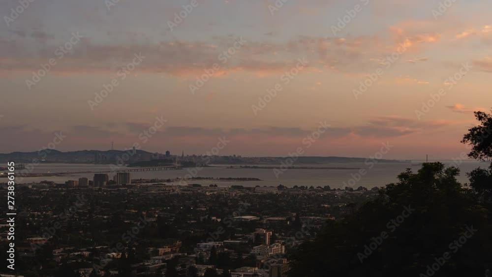 Sun setting over San Francisco and the Golden Gate Bridge on a clear Summer night. Seen from Berkeley Hills, California. Sun setting over San Francisco and the Golden Gate Bridge on a clear Summer night. Seen from Berkeley Hills, California.