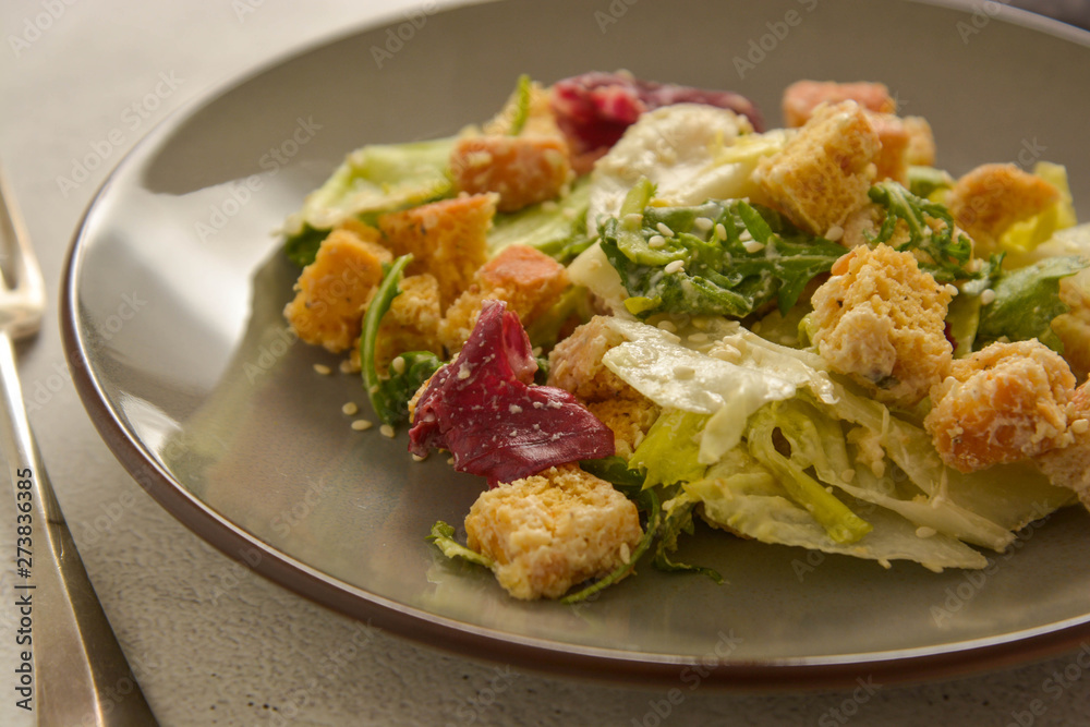 Close up caesar salad with croutons and dressing. Healthy foods. Close up caesar salad with croutons and dressing. Healthy foods.