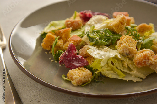 Close up caesar salad with croutons and dressing. Healthy foods.