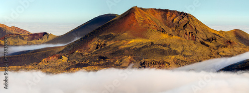 Volcanoes in the Timanfaya national park on Lanzarote. Volcanoes rising out of the clouds