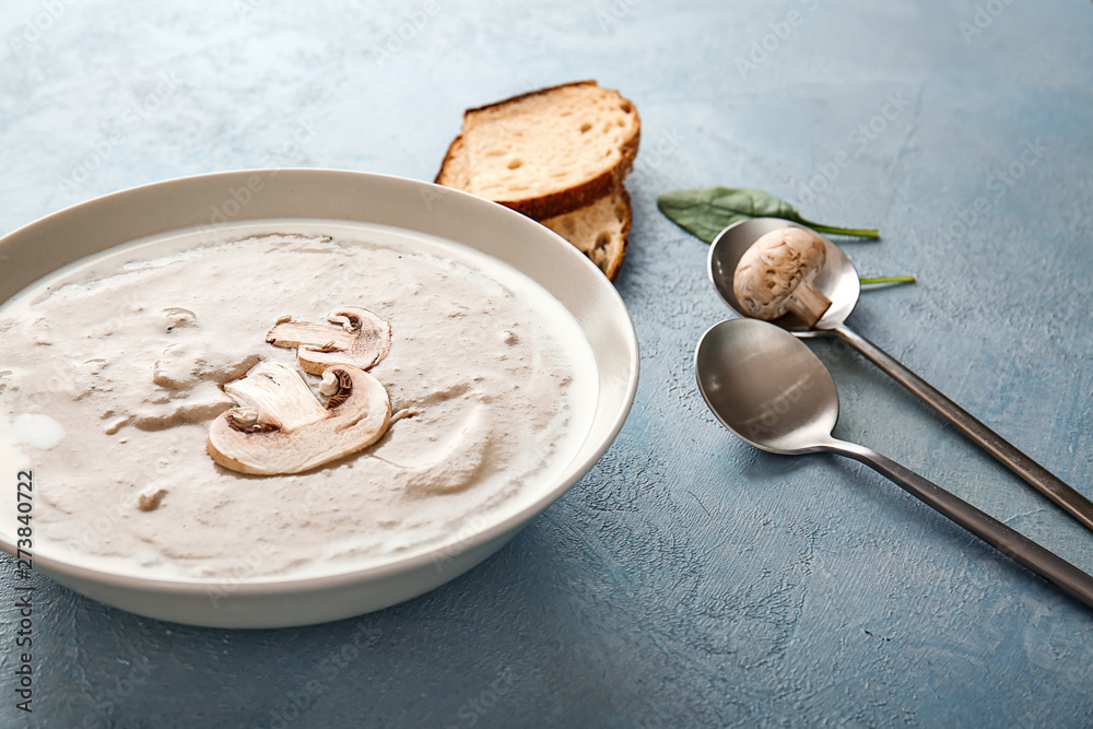Bowl with delicious mushroom cream soup on color background Bowl with delicious mushroom cream soup on color background