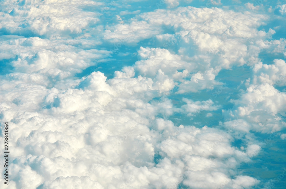 Naklejka premium White clouds and blue sky view from airplane window. - Image