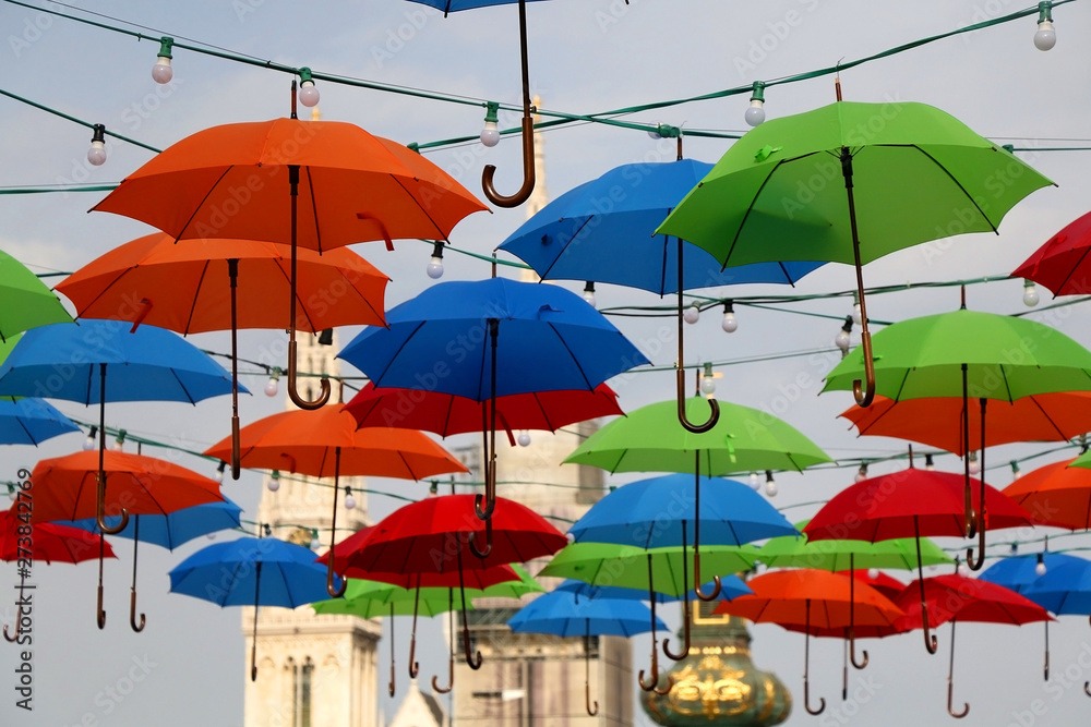 Colorful umbrellas on the street of Zagreb, Croatia. Cathedral of the Assumption of the Blessed Virgin Mary in the background. Selective focus.