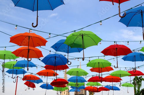 Colorful umbrellas on the street of Zagreb  Croatia. Cathedral of the Assumption of the Blessed Virgin Mary in the background. Selective focus.