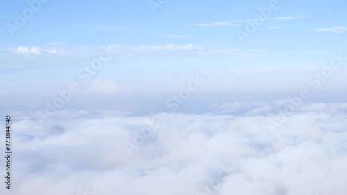 Morning fog and fluffy clouds flowing quickly through the mountain.