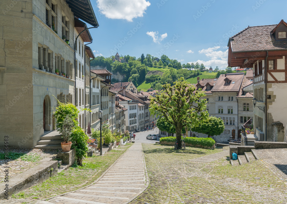 view of the historic Swiss city of Fribourg with its old town and famous chapel on the hill