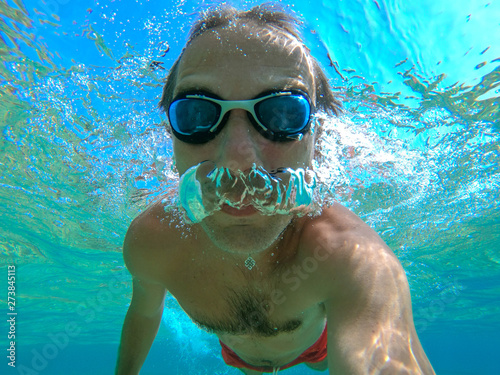 Swimmer man taking an underwater selfie
