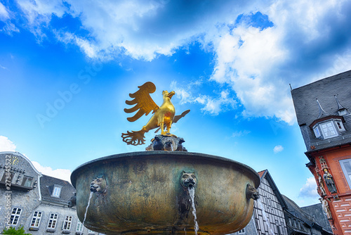 Goslar, German,y old historic market with well and golden eagle on top photo