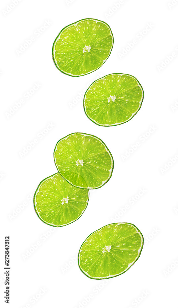 Sliced cut green lime fruits flying. Levitation Isolated on white. Citrus fruit. Falling pieces of limes in air.