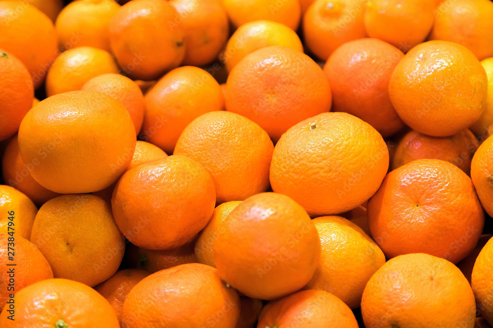 Fresh mandarin oranges for sale at fruit market. Tasty tangerine fruits are full of vitamins and minerals Fresh mandarin oranges for sale at fruit market. Tasty tangerine fruits are full of vitamins and minerals