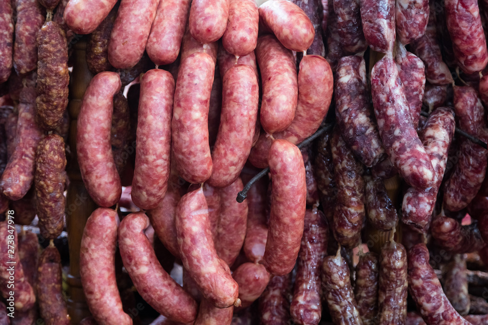 Home made smoked sausages for sale at meat market. Traditionally smoked meat on display at the market Home made smoked sausages for sale at meat market. Traditionally smoked meat on display at the market