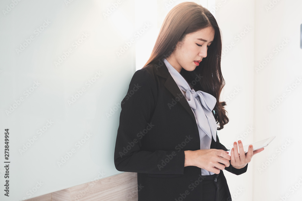 Young asian businesswoman holding tablet while she working at the office. Young asian businesswoman holding tablet while she working at the office.