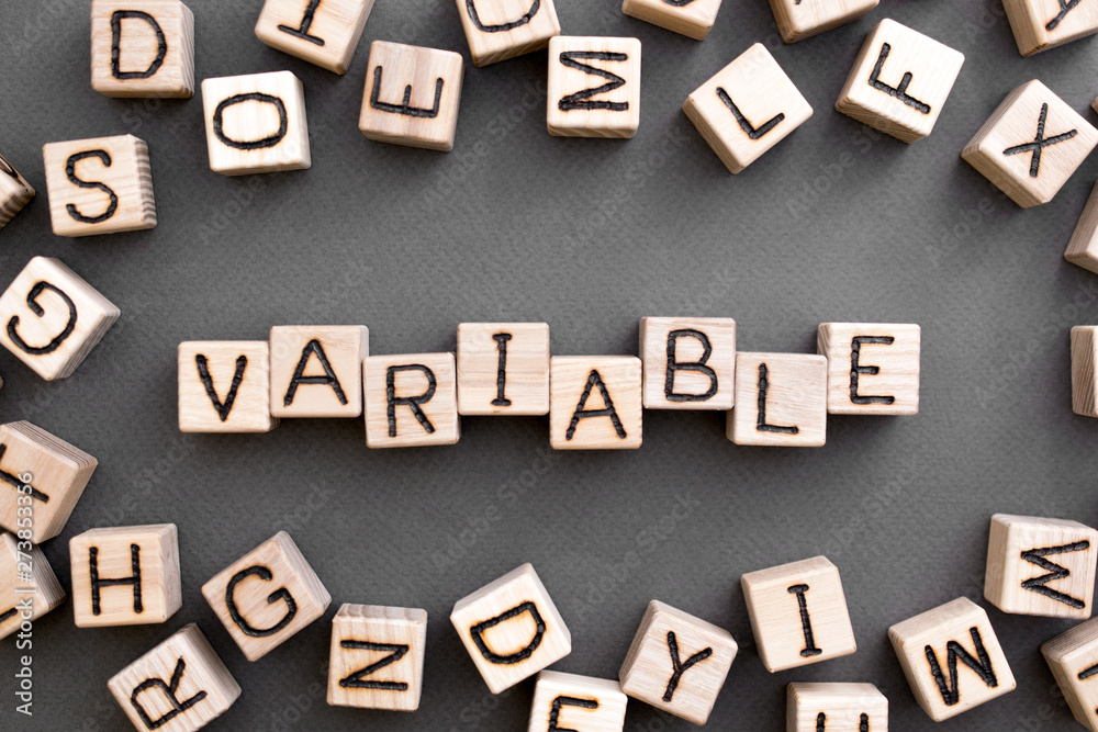 the word variable wooden cubes with burnt letters, variable life, gray background top view, scattered cubes around random letters the word variable wooden cubes with burnt letters, variable life, gray background top view, scattered cubes around random letters