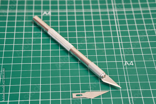 cutter knife on a green board
