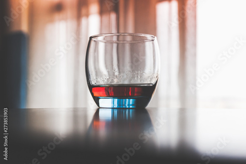 Glass of cognac stands on a table