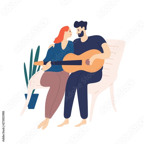 Lovely couple sitting on bench and playing guitar. Pair of young adorable man...