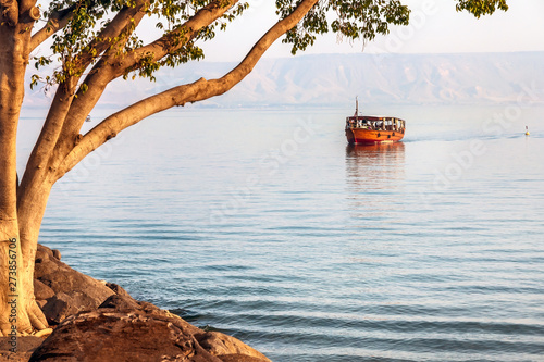 Evening walk on the boat on the Sea of Galilee. photo