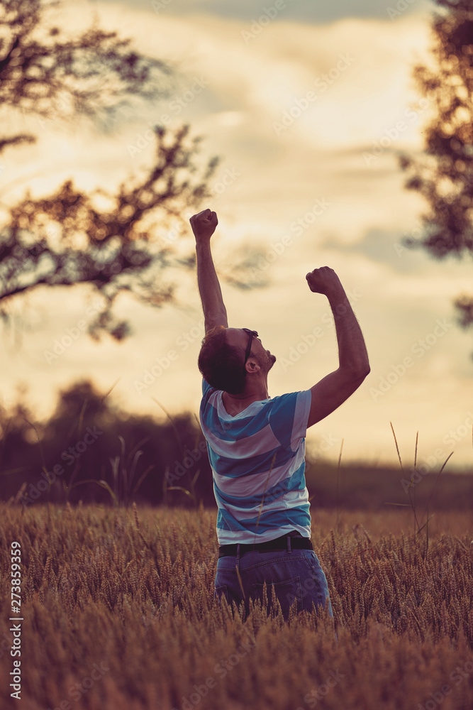 Man enjoying and relaxing in wheat field. Nature concept. Man enjoying and relaxing in wheat field. Nature concept.